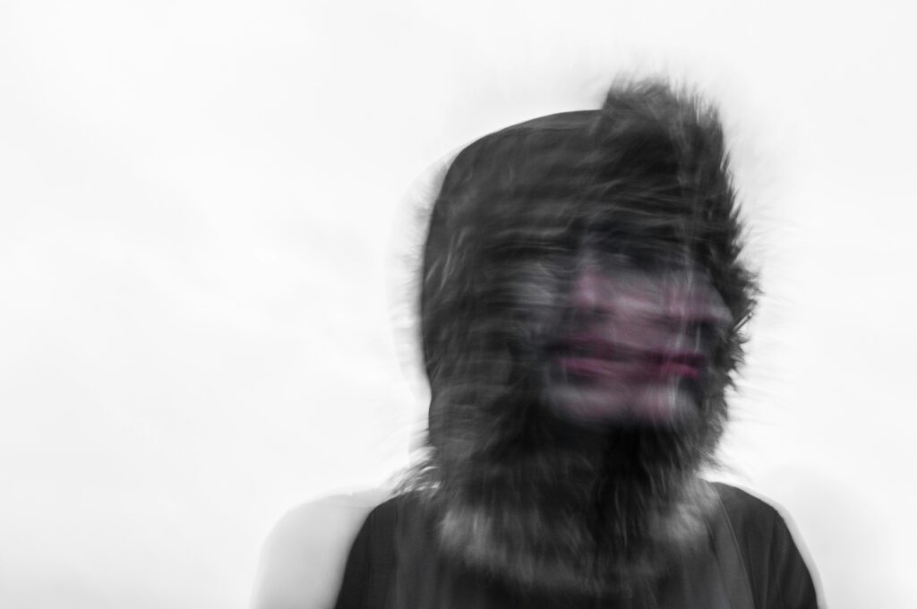 Blurred photo of a person’s face.